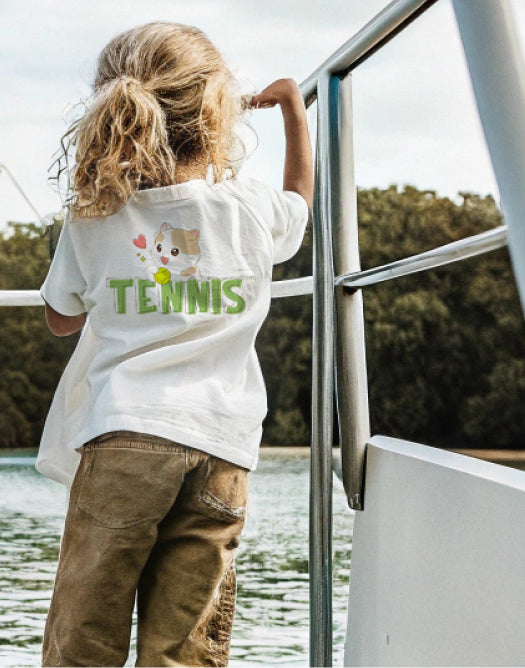Kid on a sailboat wearing the Tennis Cat t-shirt
