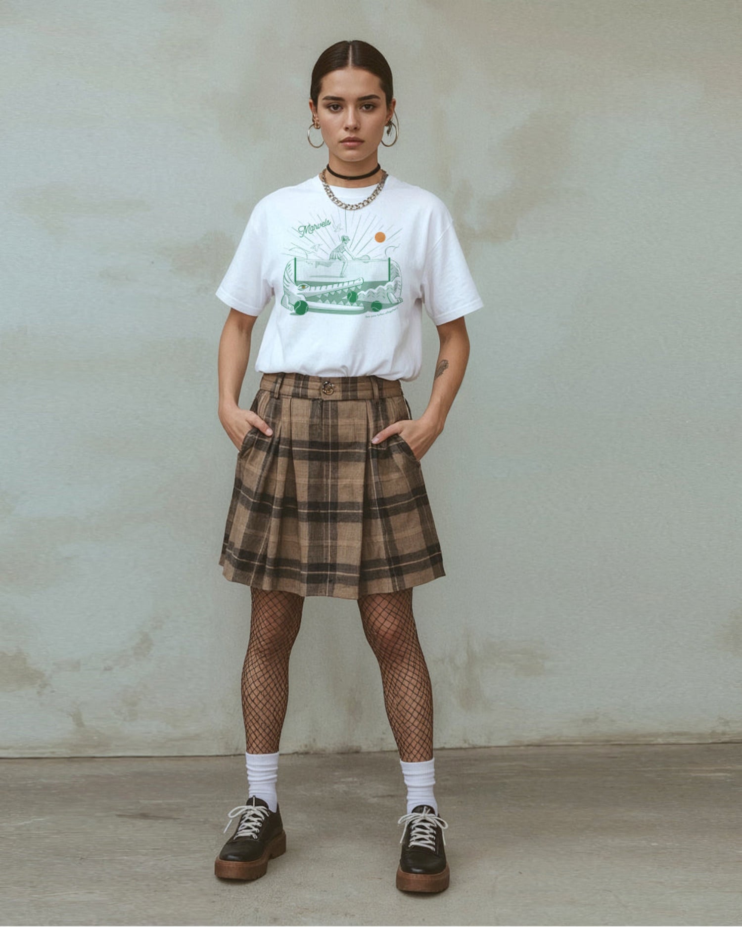 Person wearing a plaid skirt and a white t-shirt with a tennis graphic of an alligator that reads 'See you later' in text on a plain background