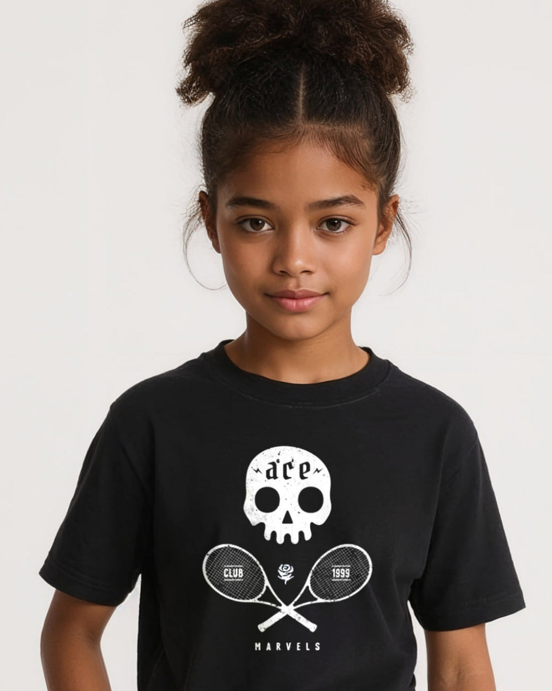 Young girl wearing a black t-shirt with a skull and tennis racket design on a white background
