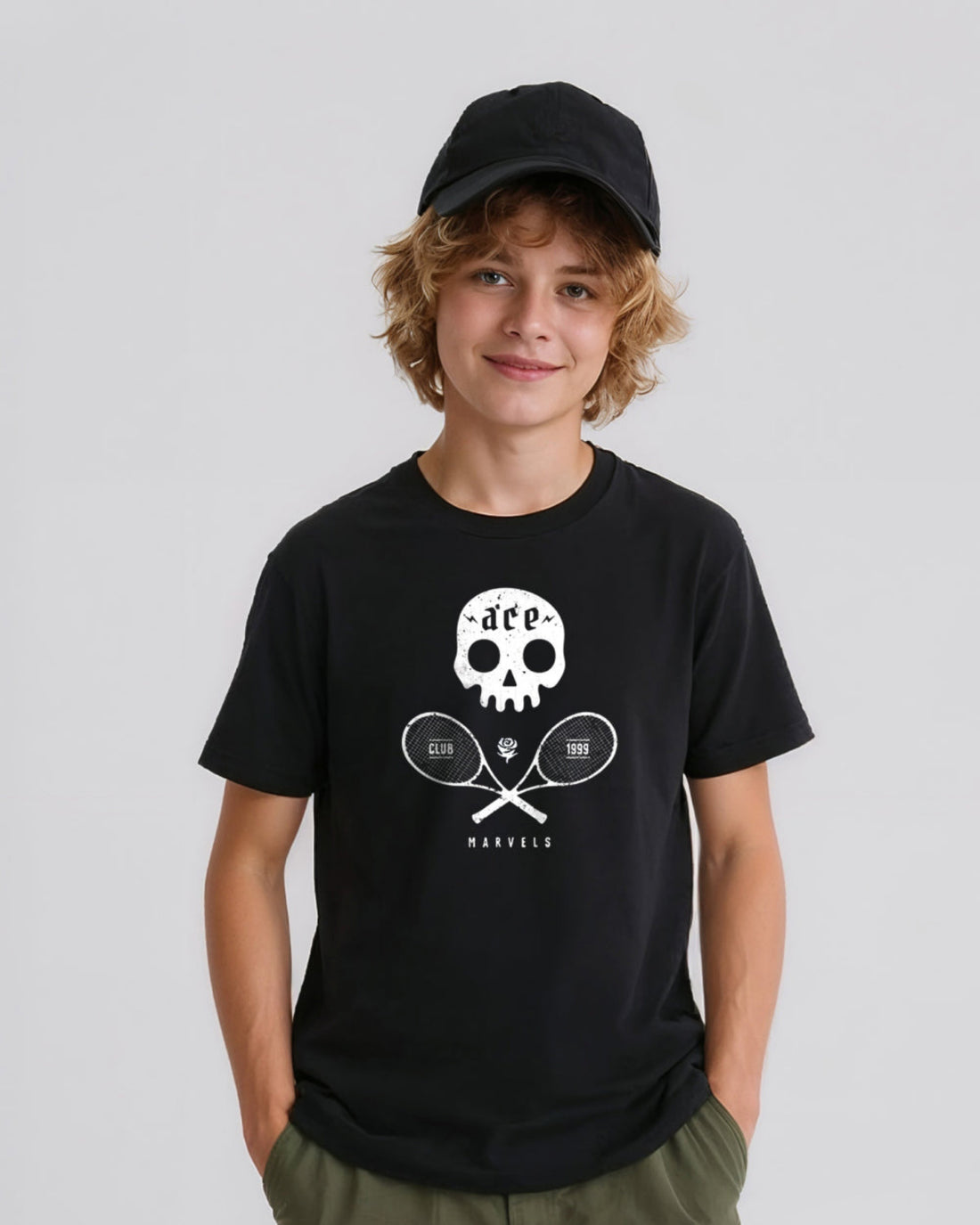 Person wearing a black t-shirt with a white  skull and crossed tennis rackets graphic design on a plain background