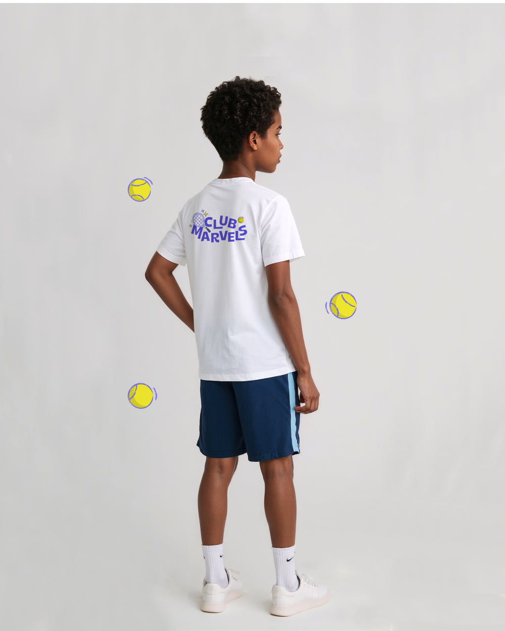 Child wearing a white 'Club Marvels' t-shirt and navy shorts on a light gray background