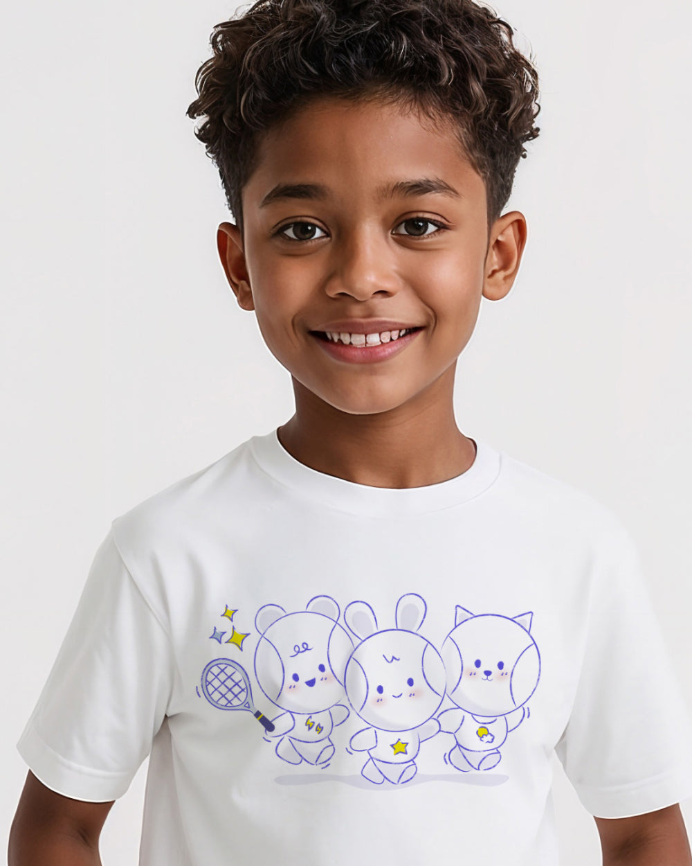 Child wearing a white t-shirt with three cute tennis ball cartoon characters
