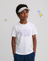 Child wearing a white t-shirt with cartoon tennis ball designs and a visor