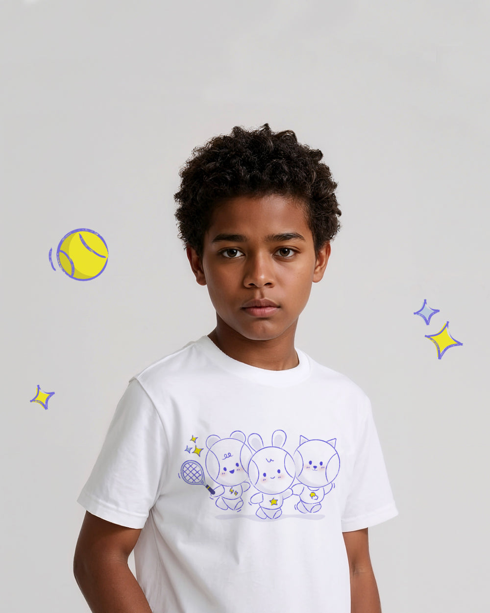 Child wearing a white t-shirt with cartoon tennis ball characters