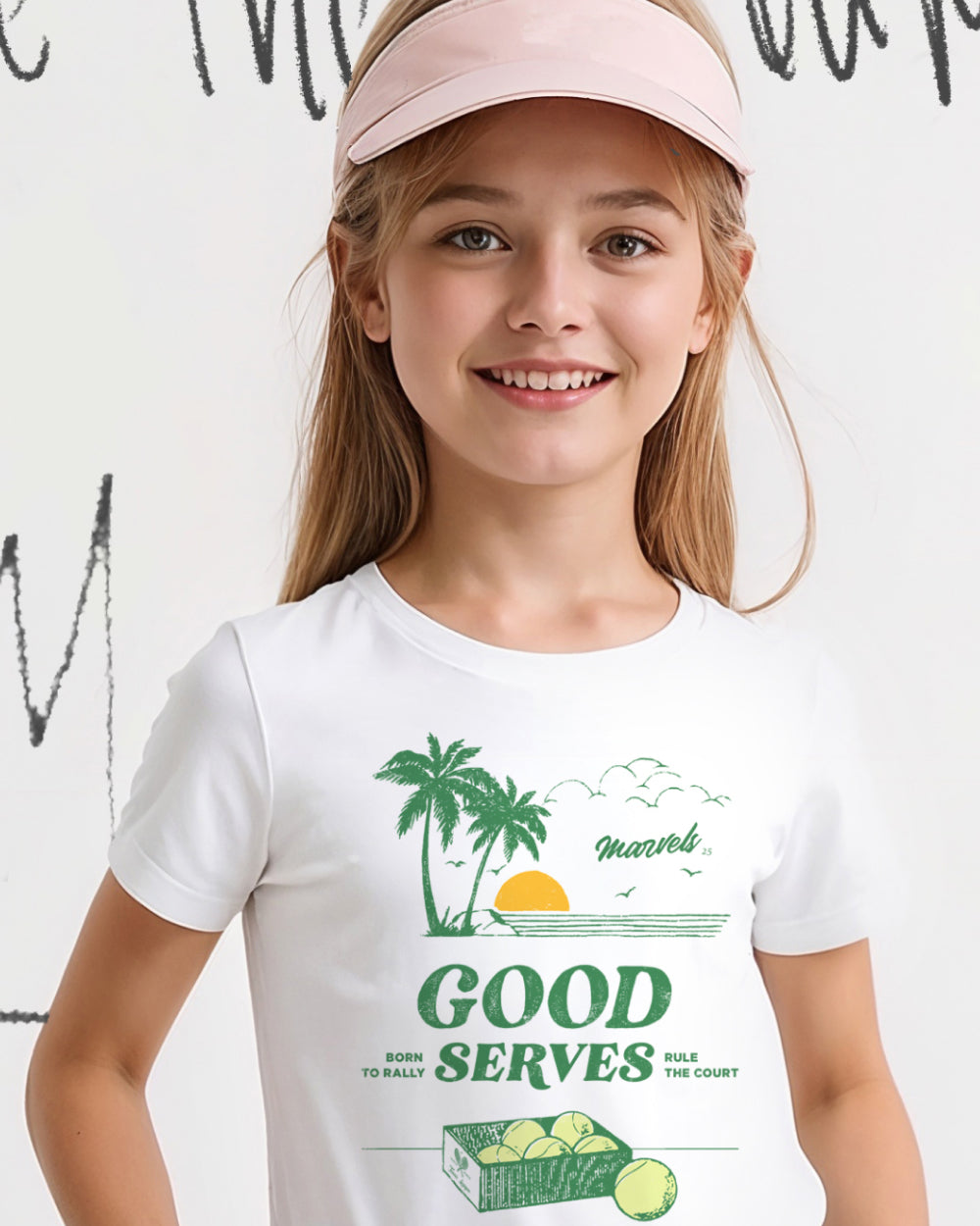 Young girl wearing a white tennis t-shirt with a graphic design and a pink visor.