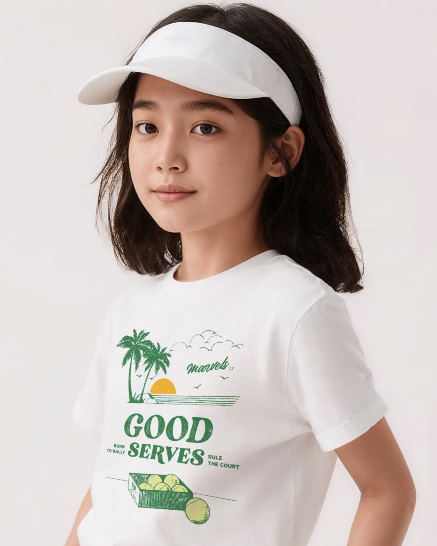 Child wearing a white t-shirt with tennis  graphics
