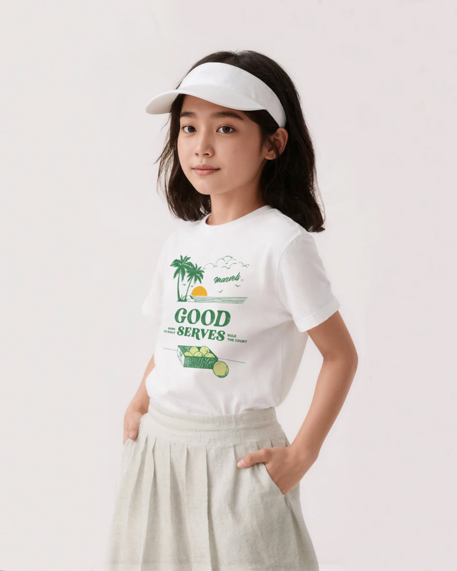 Young girl wearing a white tennis t-shirt with a graphic design and a white visor