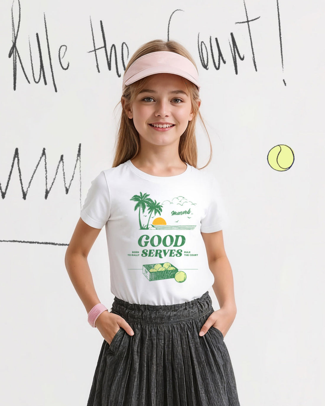 Young girl wearing a white t-shirt with a tennis-themed graphic
