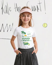 Young girl wearing a white t-shirt with a tennis-themed graphic