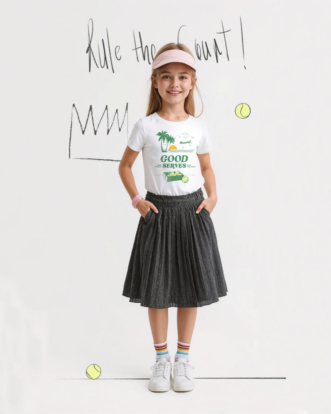 Young girl in sports attire with 'Good Serves' t-shirt and tennis-themed background