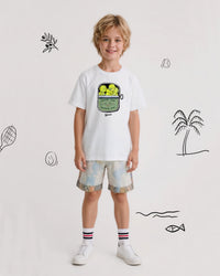 Child wearing a white t-shirt with a tennis graphic design