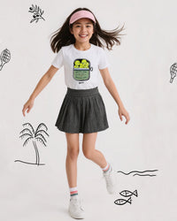 Young girl in sports-themed outfit with tennis graphics