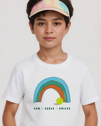 Child wearing a white t-shirt with a rainbow and tennis ball design