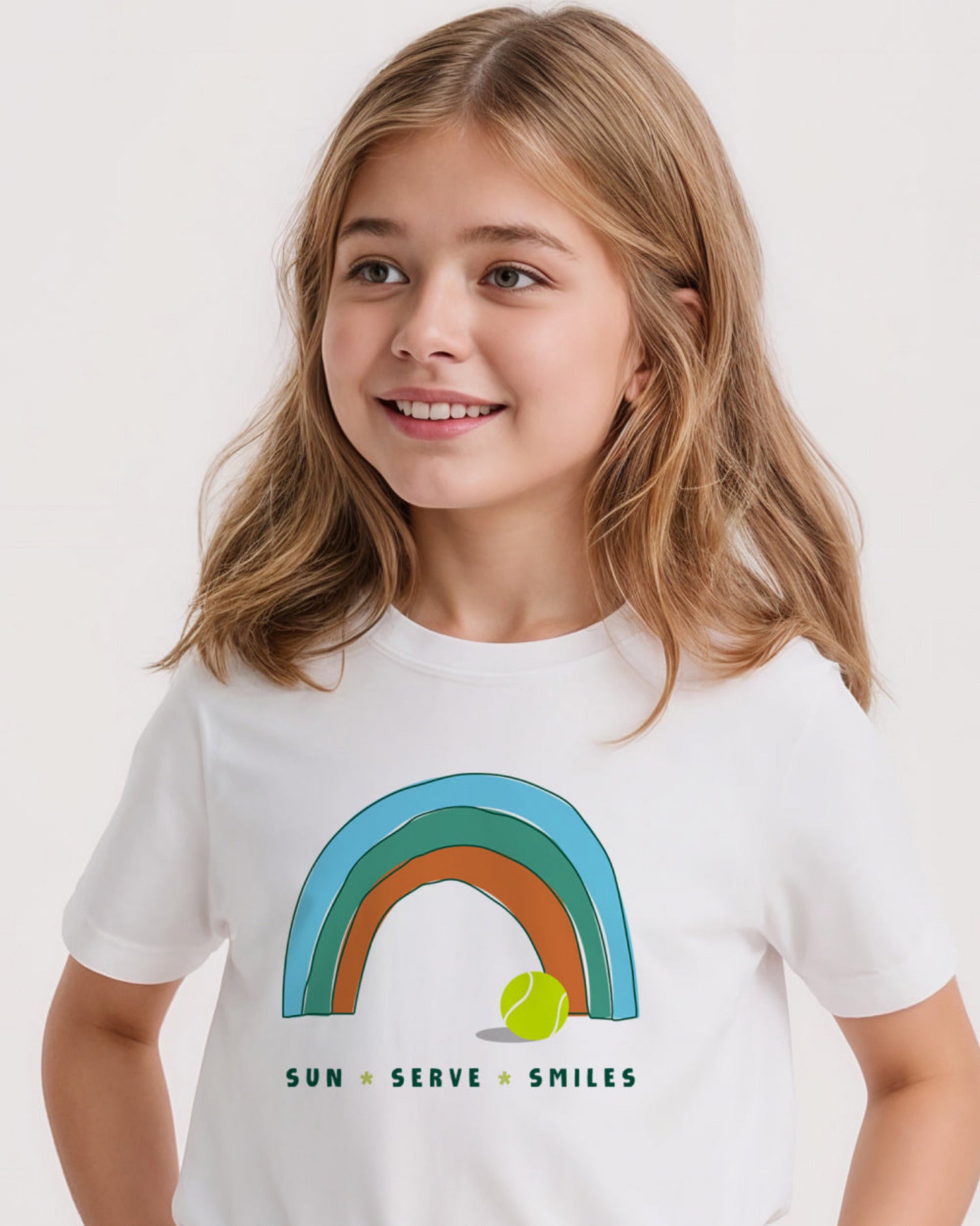 Young girl wearing a white tennis t-shirt with a rainbow design