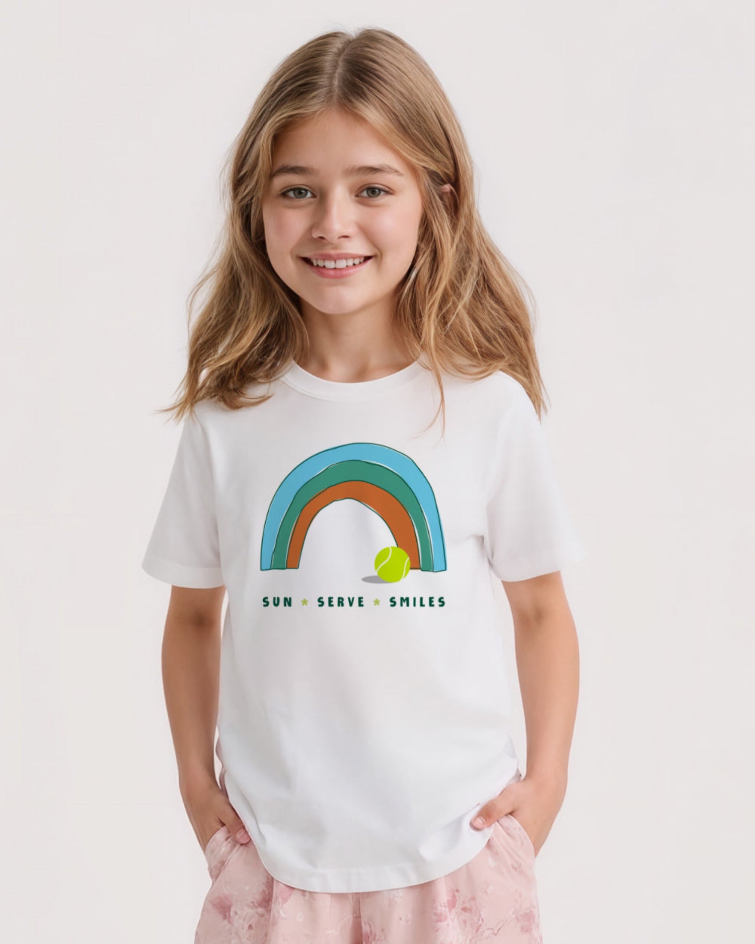 Young girl wearing a white tennis t-shirt with a colorful rainbow design