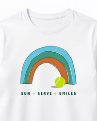 White t-shirt with a rainbow and tennis ball design on a white background