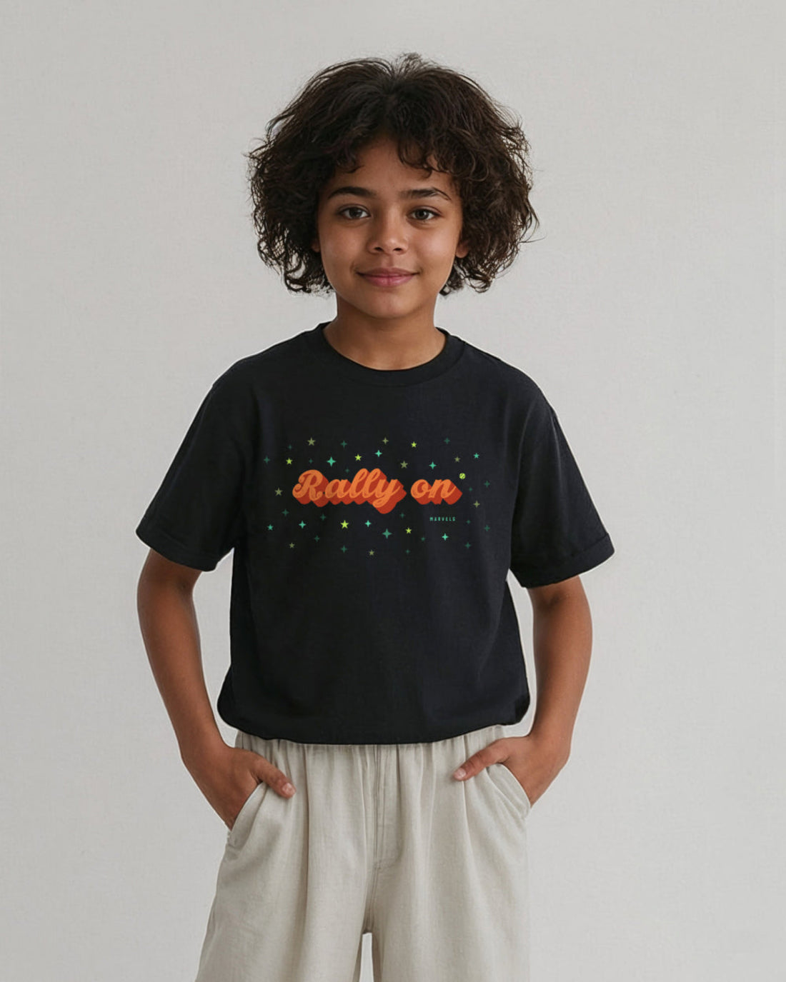Child wearing a black tennis t-shirt with 'Rally on' text on the front