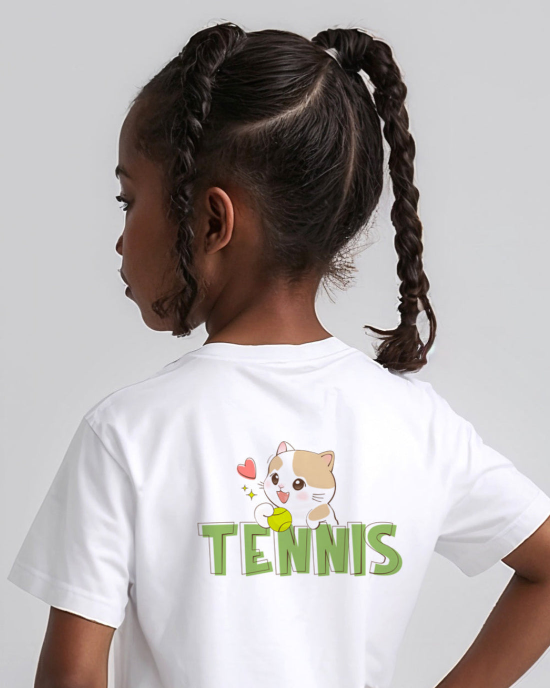 Child wearing a white t-shirt with a tennis-themed cat design on the back.