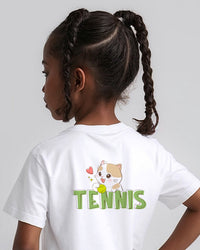 Child wearing a white t-shirt with a tennis-themed cat design on the back.