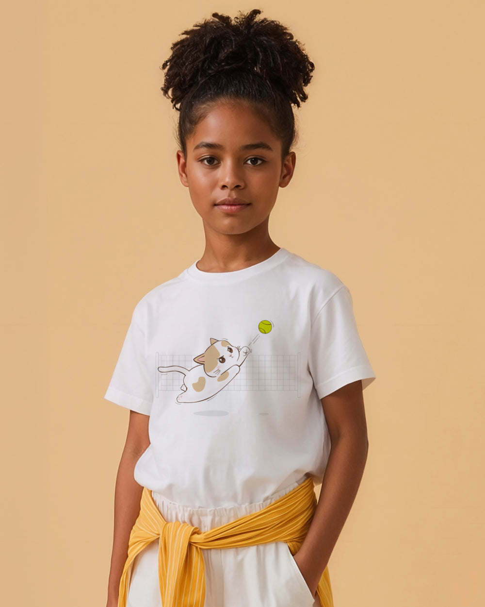 Young girl wearing a white t-shirt with a tennis cat graphic