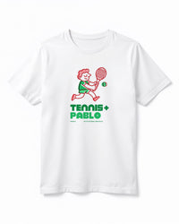 White t-shirt with a graphic of a person playing tennis and text 'TENNIS + PABLO' on a white background
