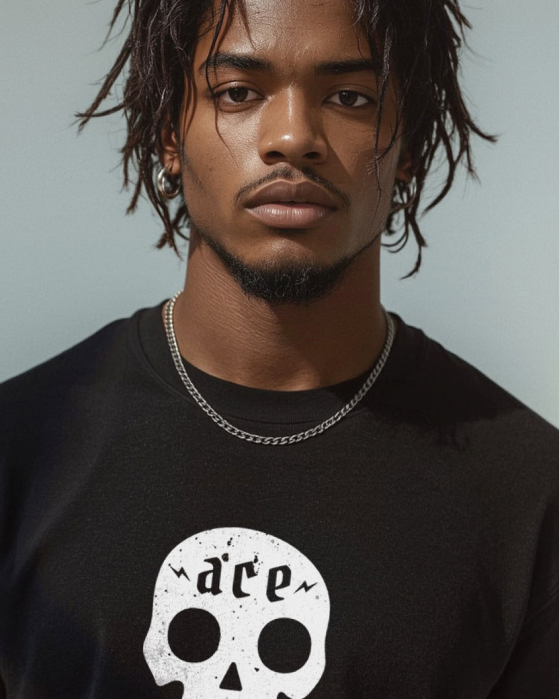 Man wearing a black t-shirt with a skull design and 'ace' text.