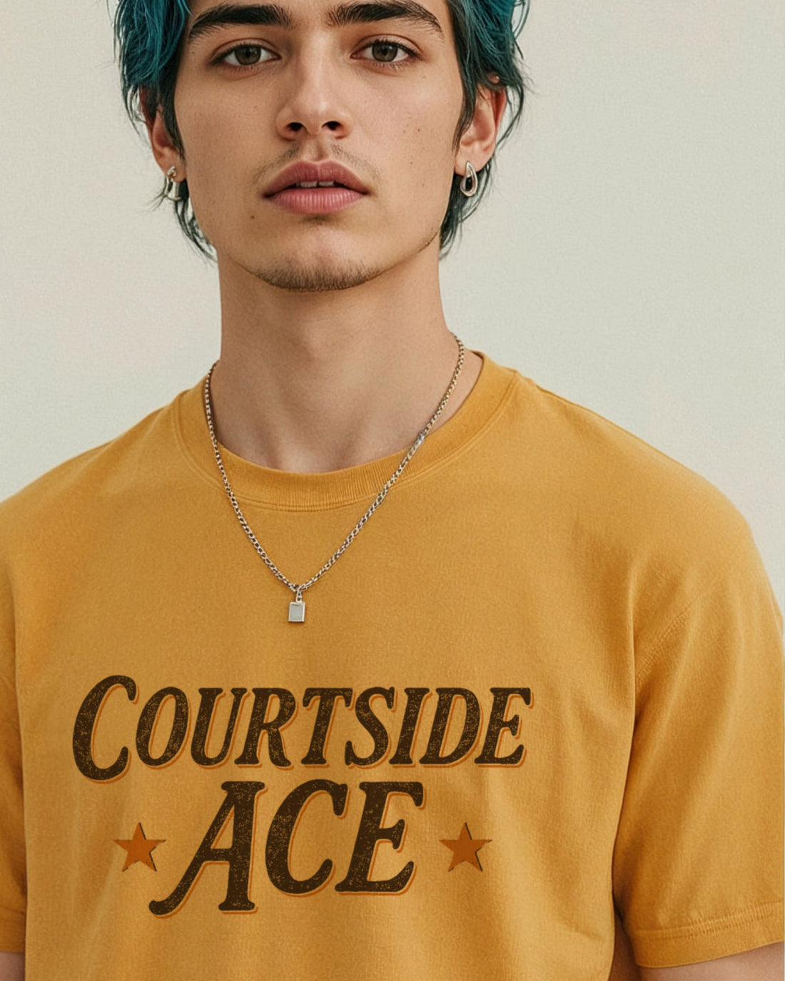 Person wearing a yellow gold 'Courtside Ace' t-shirt with a plain background