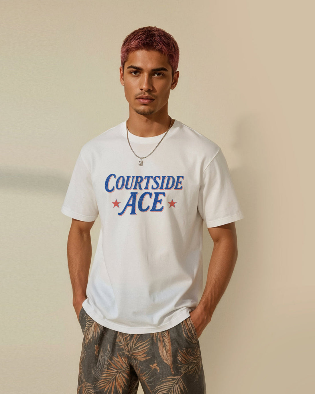 Man wearing a white t-shirt with 'Courtside Ace' text and red stars on a beige background