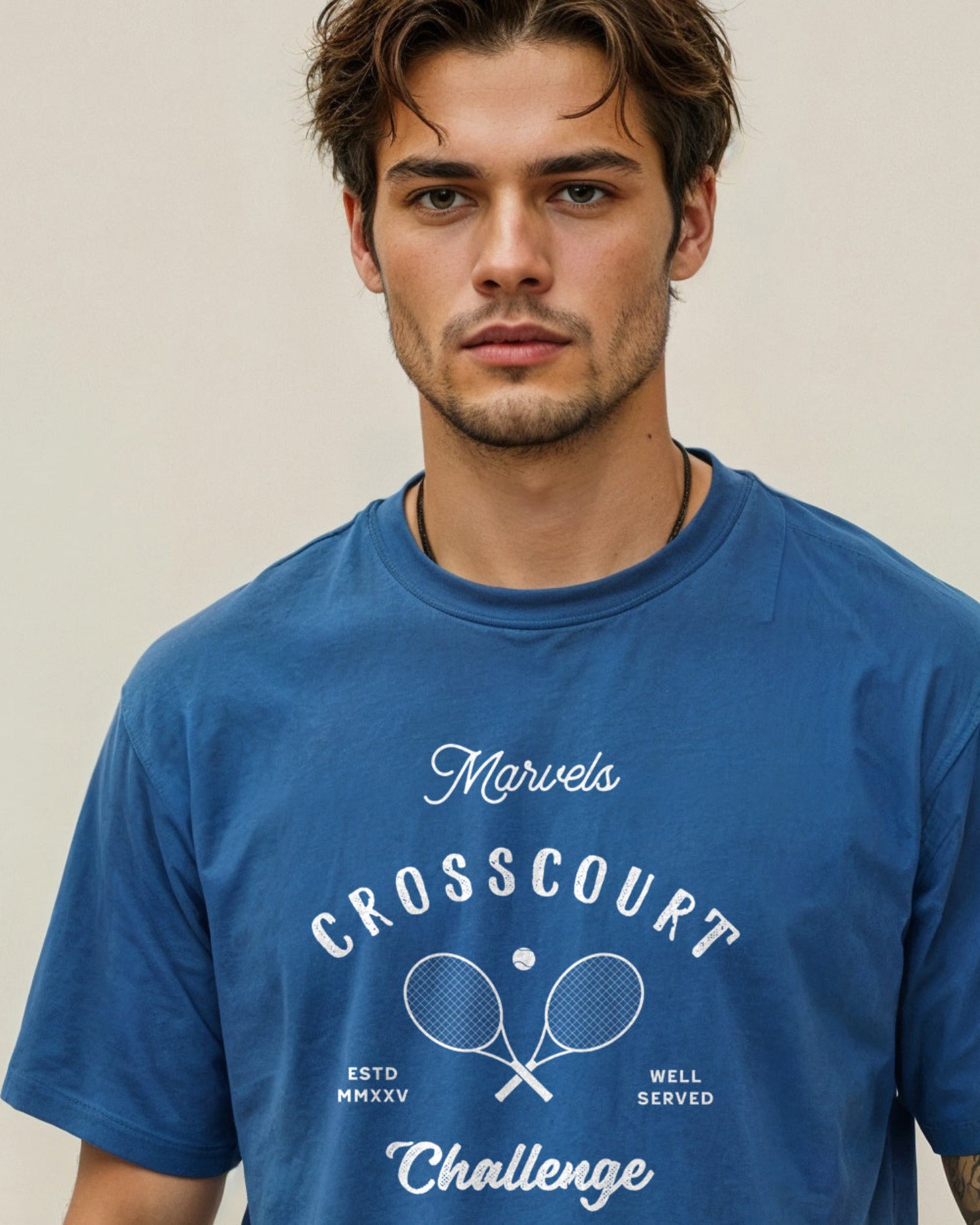 Man wearing a blue tennis t-shirt with 'Crosscourt Challenge' text and logo