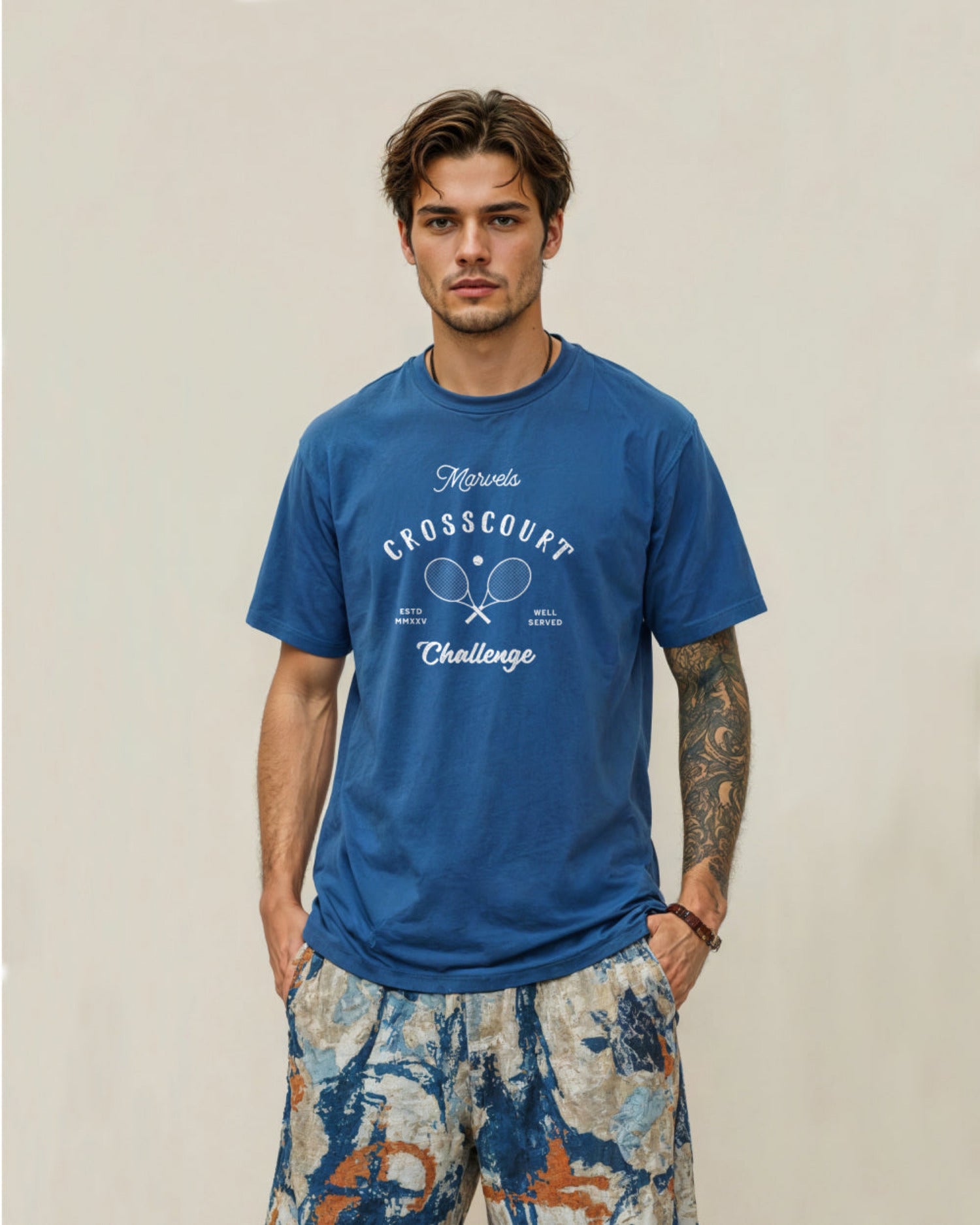 Man wearing a blue tennis t-shirt with text and graphics on a beige background