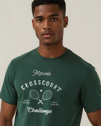 Man wearing a green t-shirt with 'Marvels Crosscourt Challenge' text and graphic on a plain background