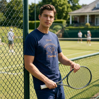 Man holding a tennis racket on a tennis court with a fence in the foreground
