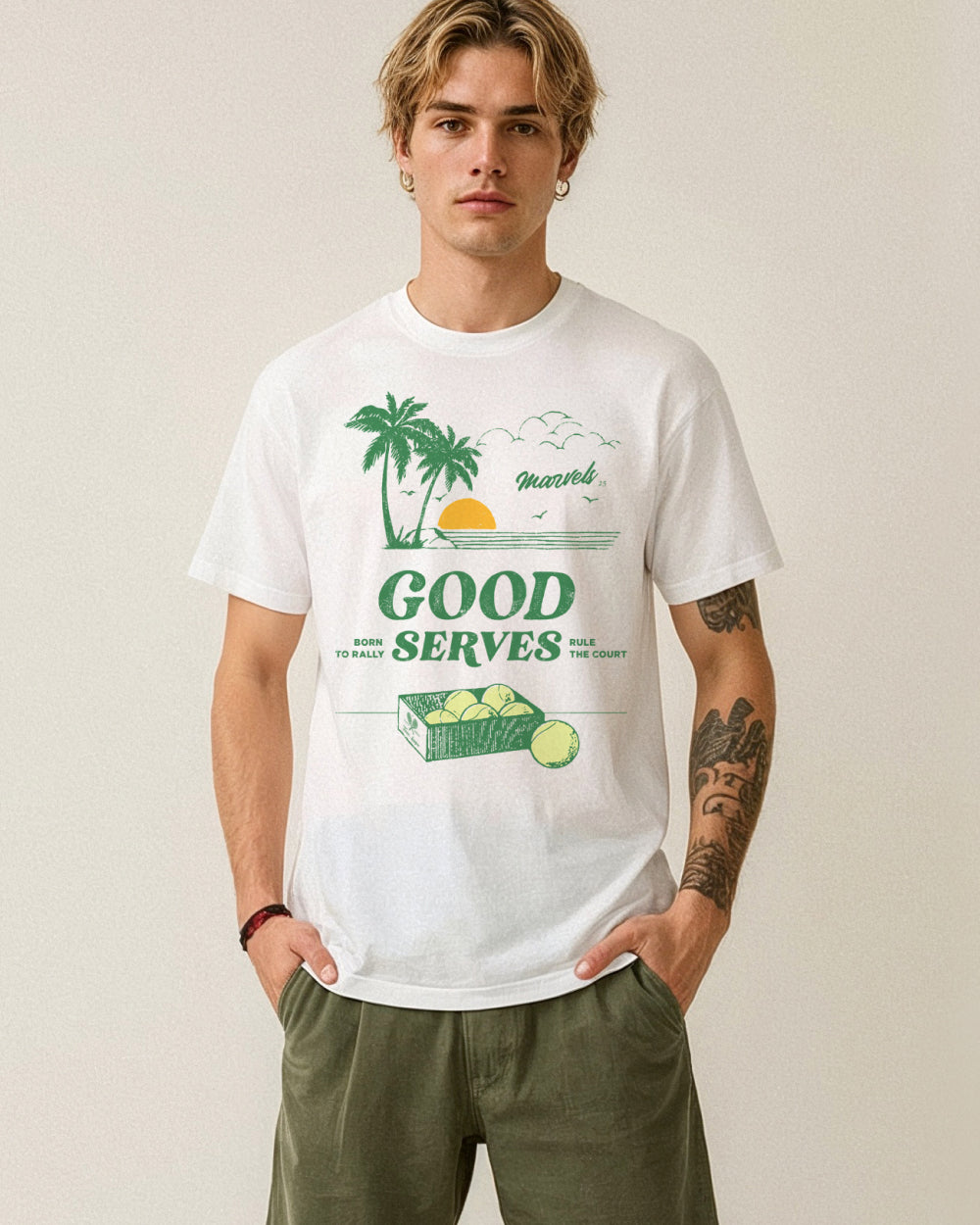 Person wearing a white t-shirt with a graphic 'Good Serves' design on a plain background