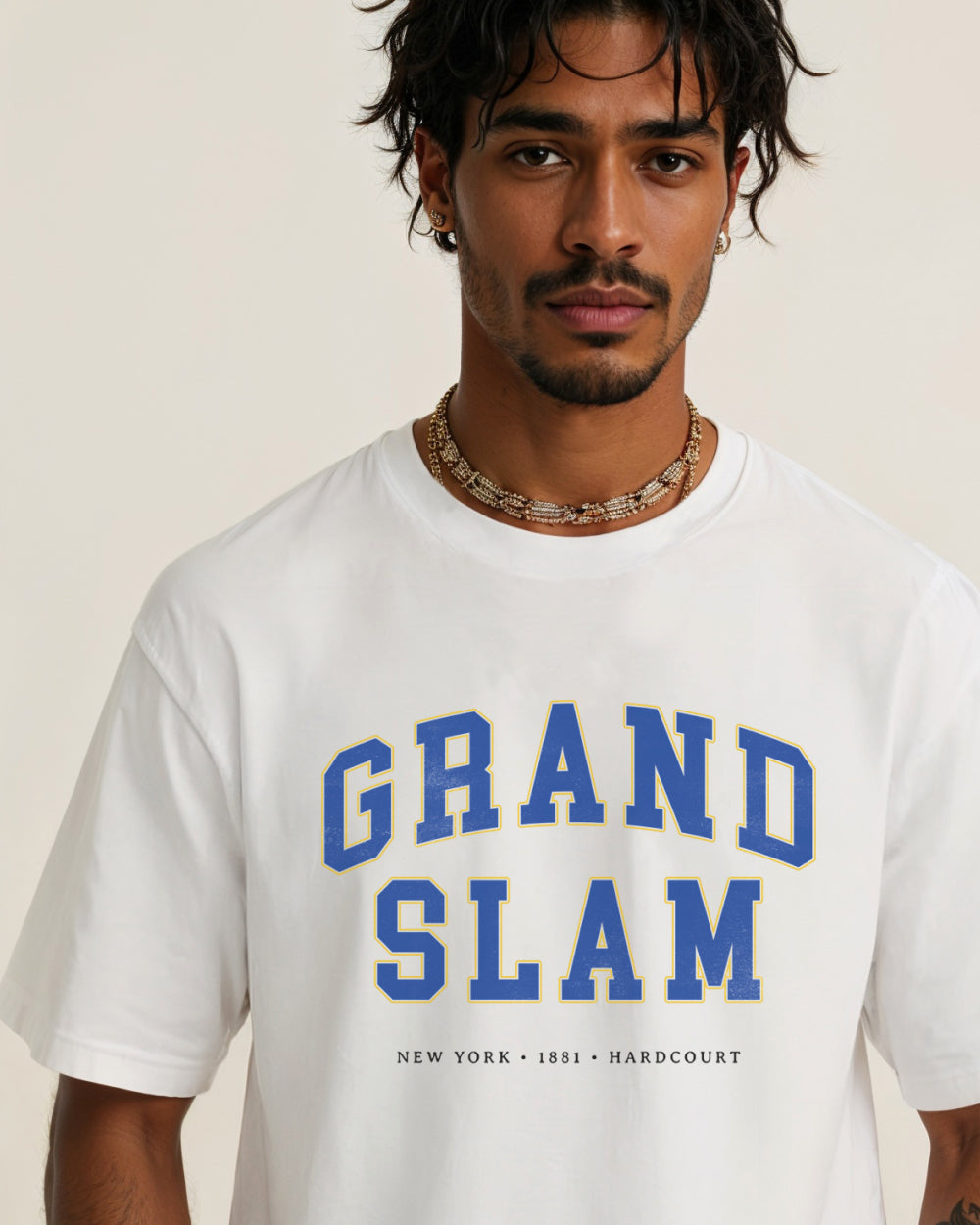 Man wearing a white t-shirt with 'Grand Slam' text on a plain background