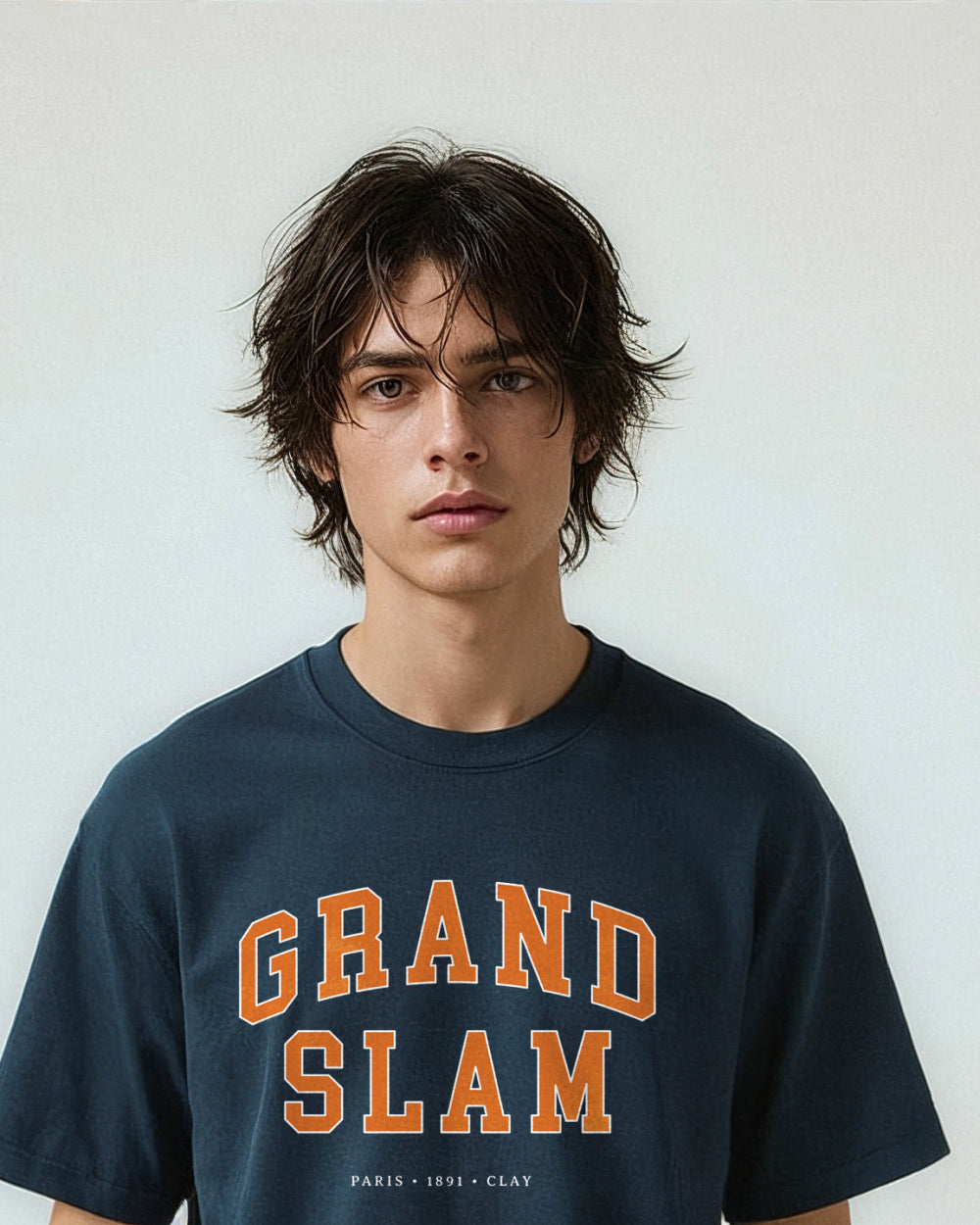 Person wearing a navy blue t-shirt with 'Grand Slam' text on a plain background