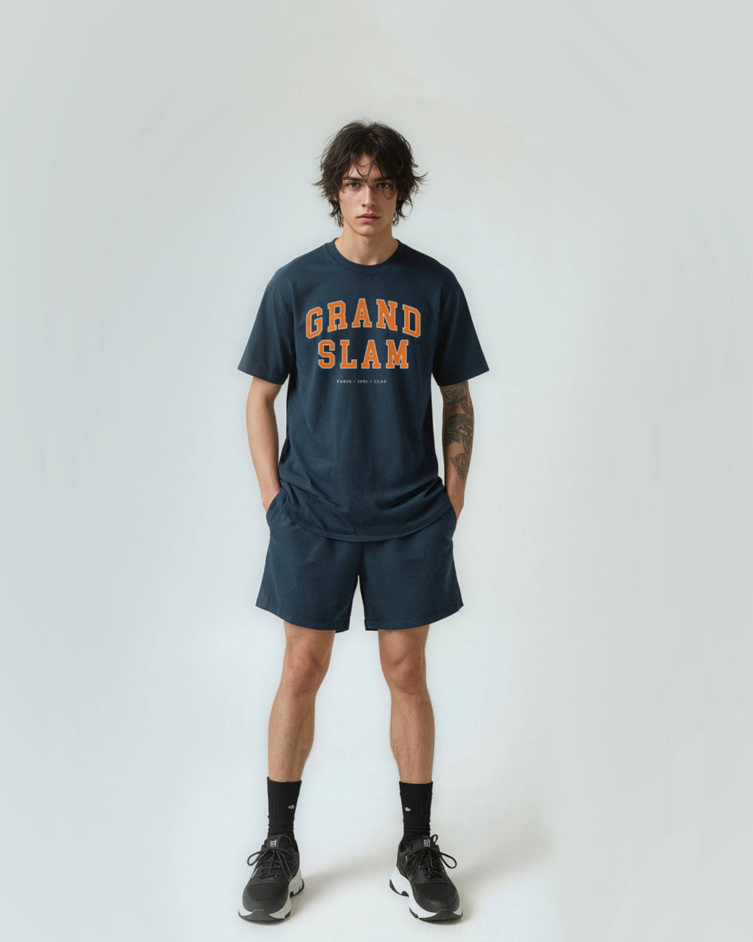 Person wearing a 'Grand Slam' t-shirt and shorts on a white background
