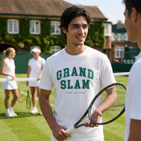 Man holding a tennis racket on a tennis court with 'Grand Slam' t-shirt