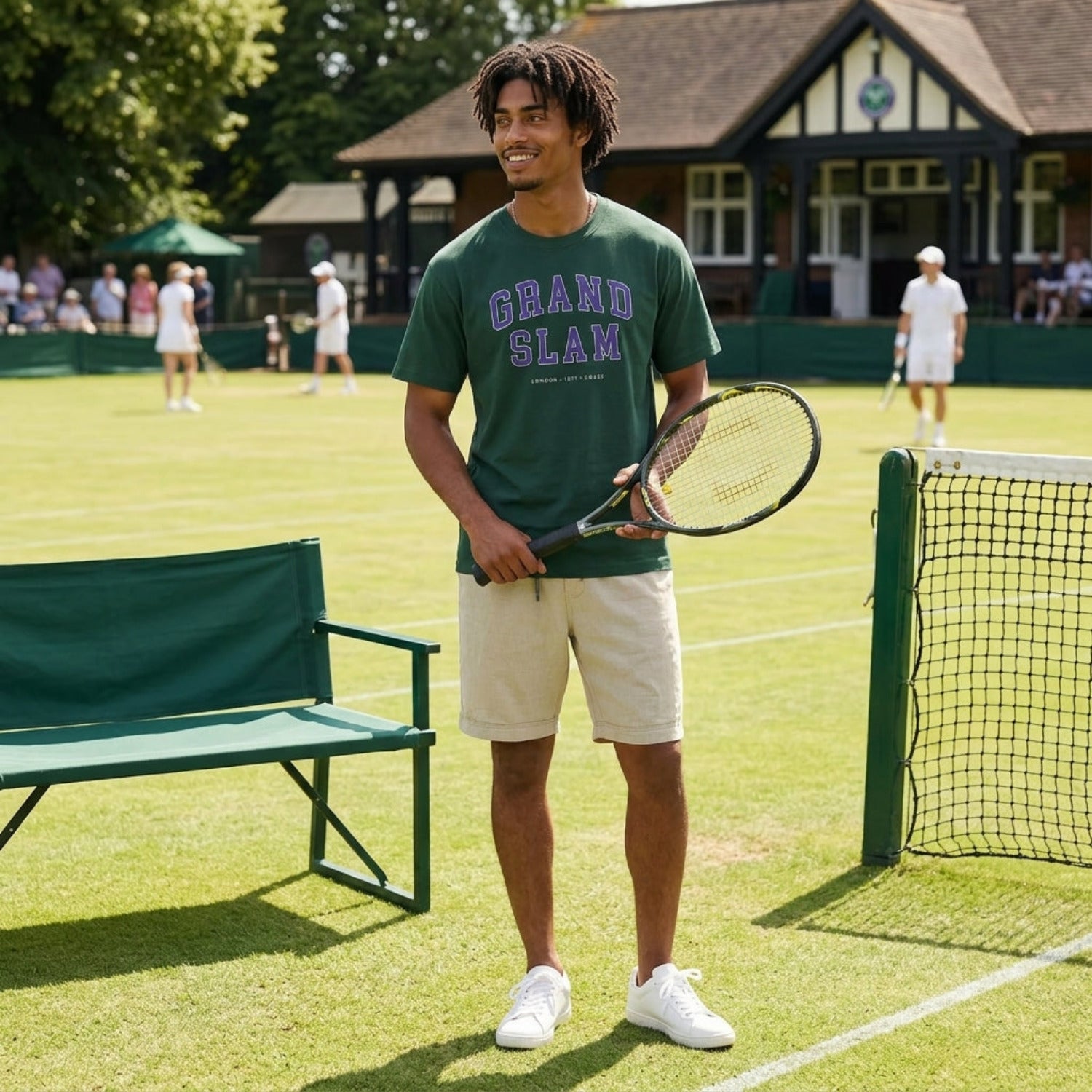 Person holding a tennis racket on a tennis court with a green bench and club building in the background.