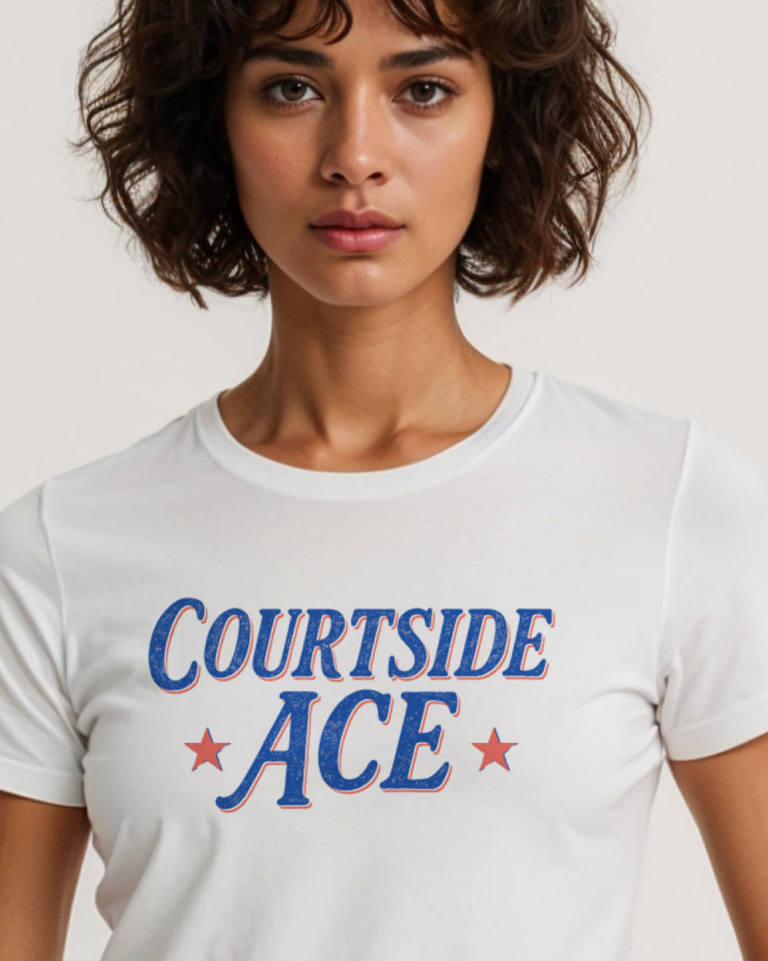 Person wearing a white t-shirt with 'COURTSIDE ACE' text and stars.