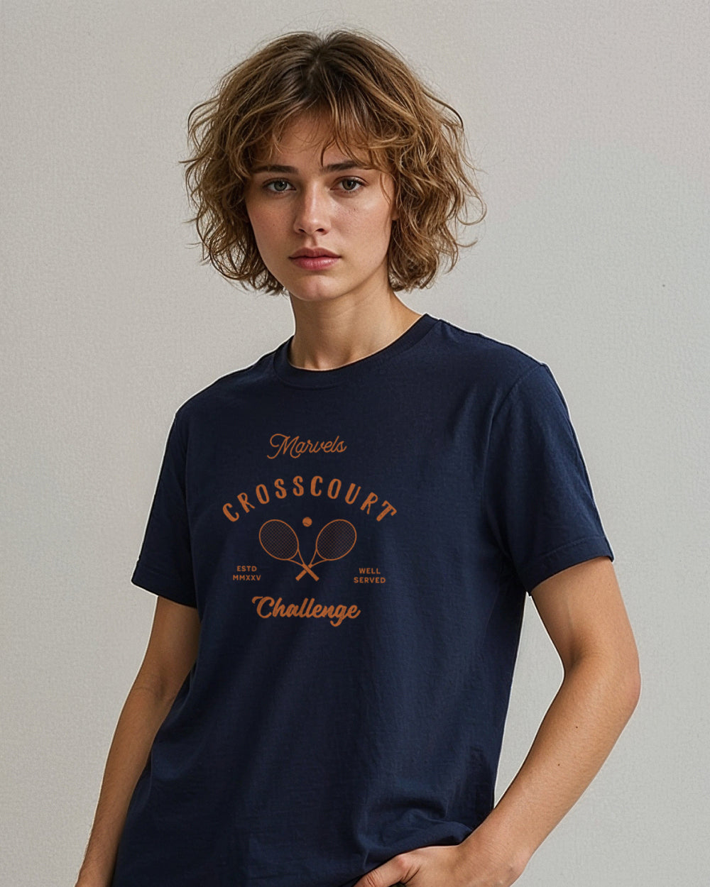 Person wearing a navy blue t-shirt with 'Marvels Crosscourt Challenge' print on a plain background