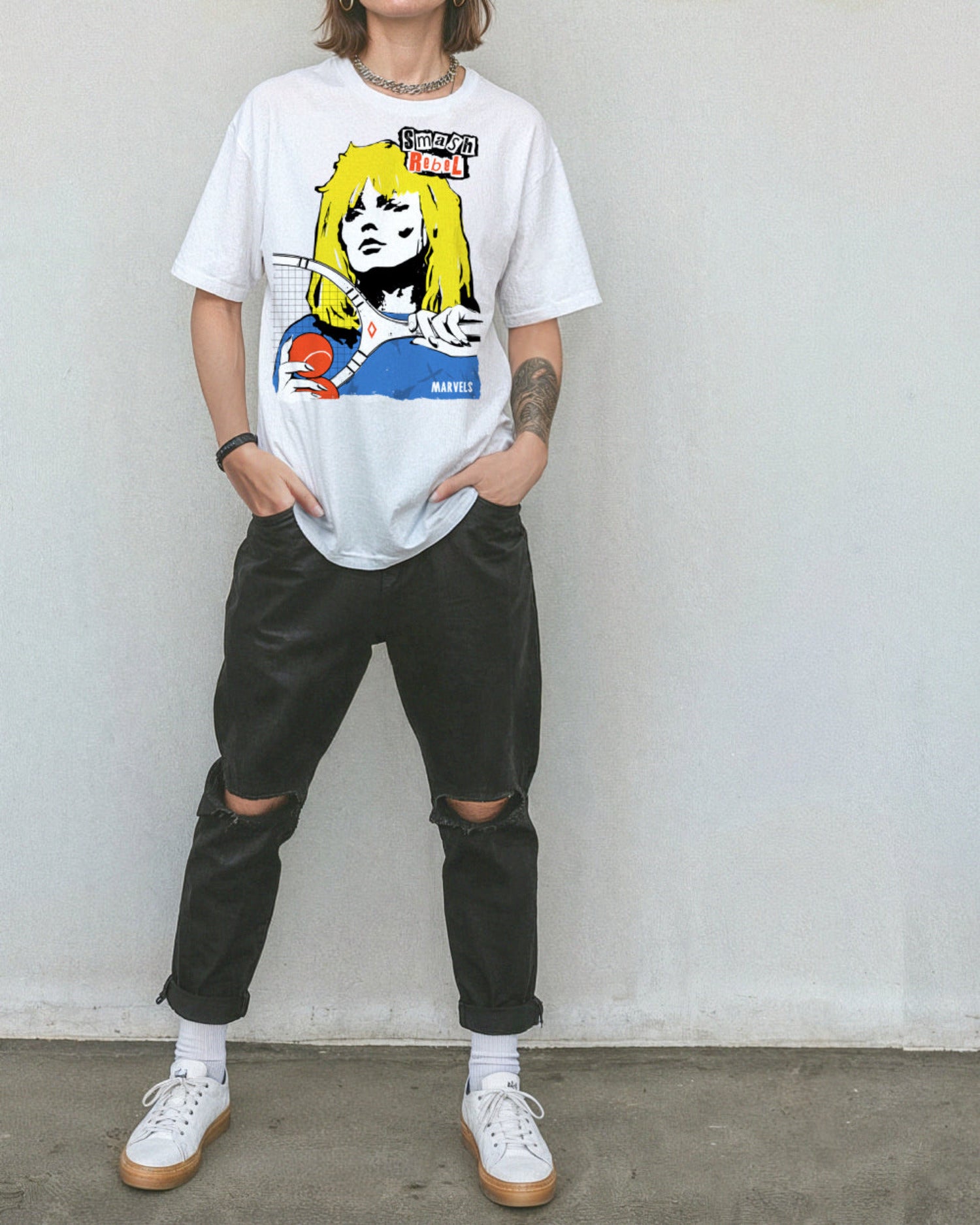 Person wearing black pants and a white t-shirt with a tennis-themed graphic that reads, 'Smash Rebel'.