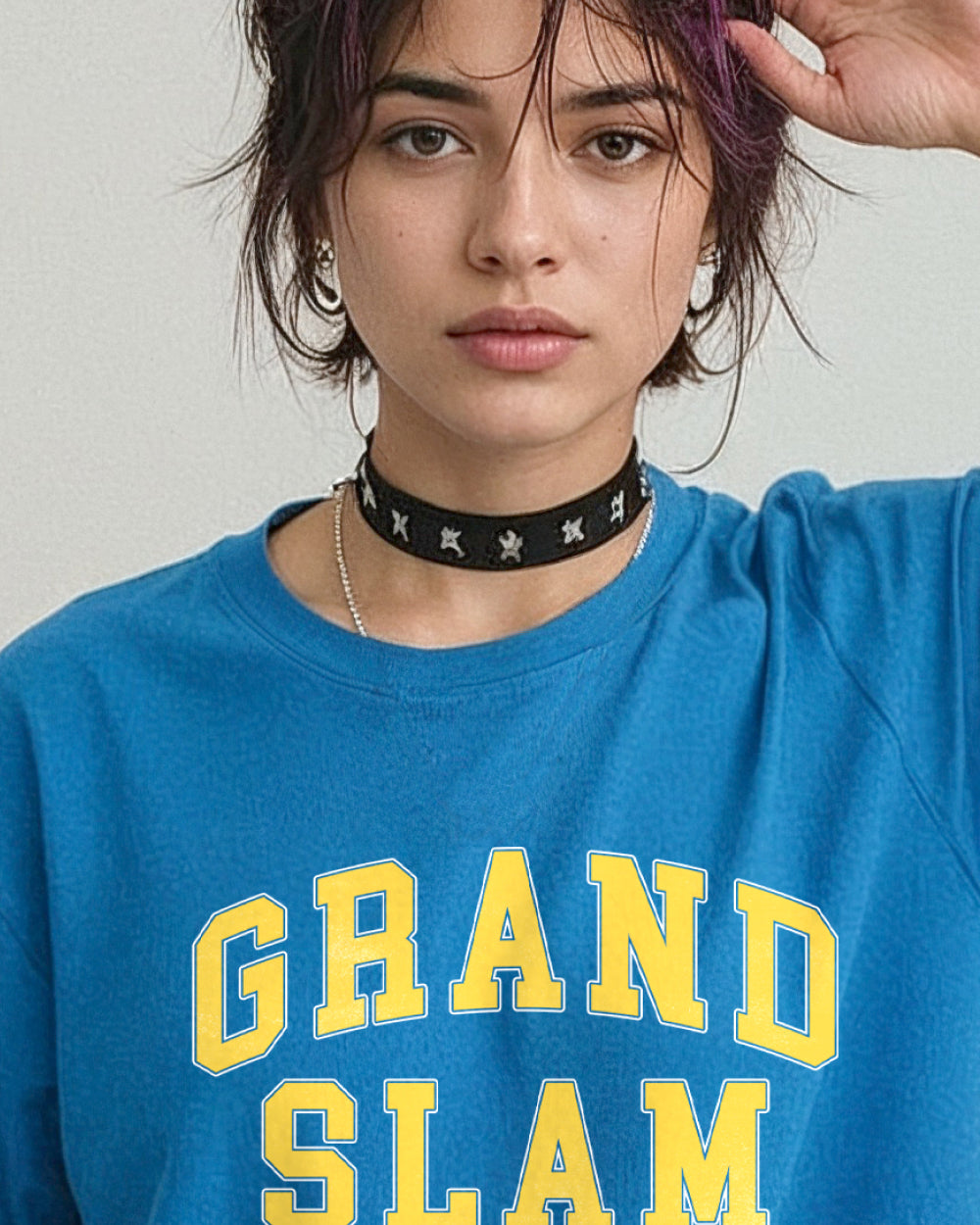 Person wearing a blue t-shirt with 'GRAND SLAM' text graphic