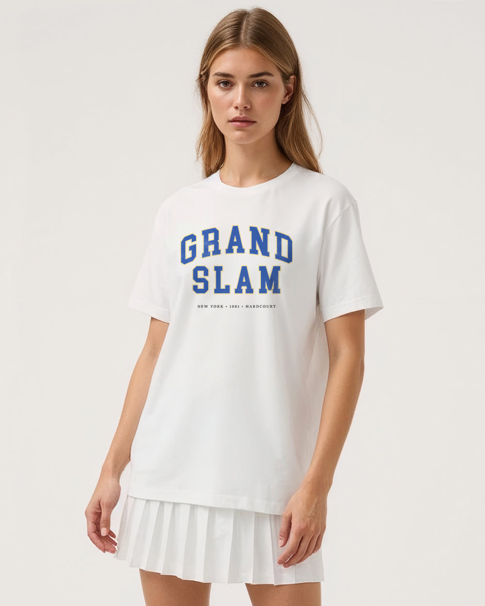 Woman wearing a white t-shirt with 'Grand Slam' text on a plain background