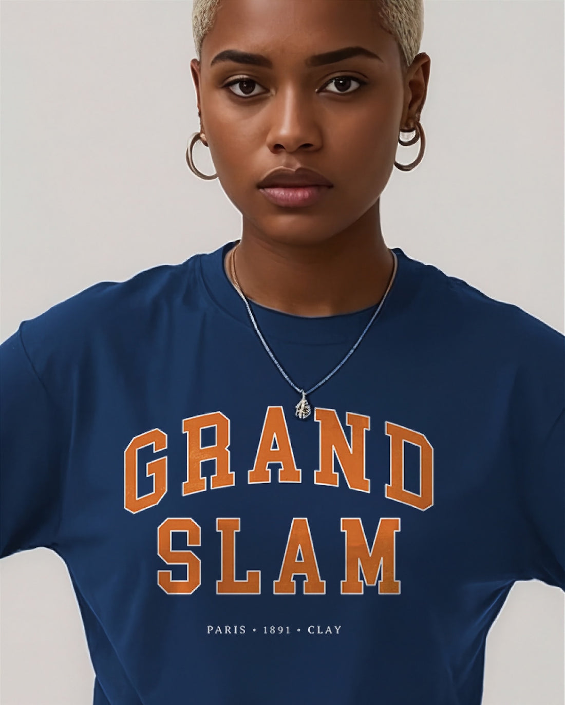 Person wearing a navy blue t-shirt with 'GRAND SLAM' text