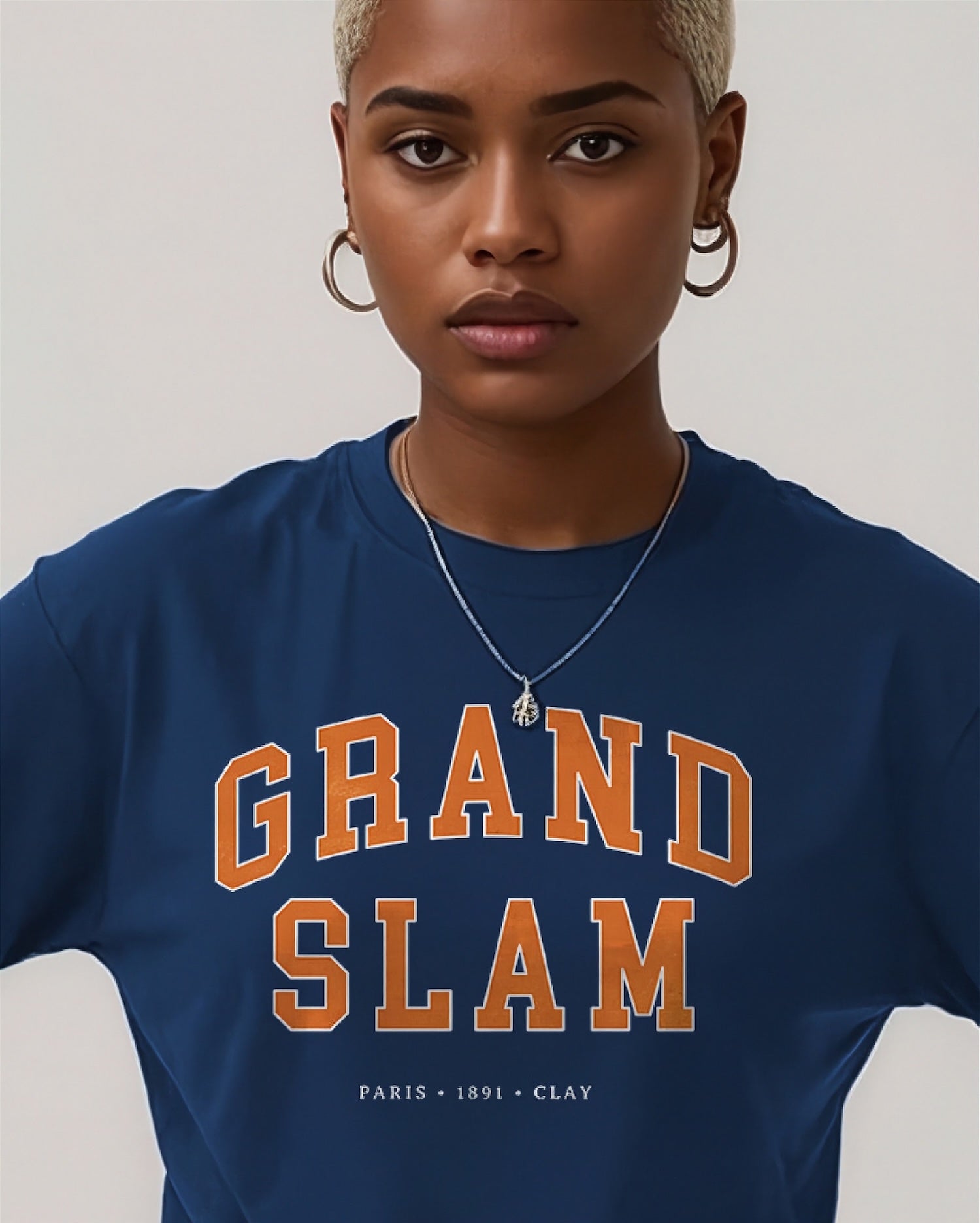 Person wearing a navy blue t-shirt with 'GRAND SLAM' text