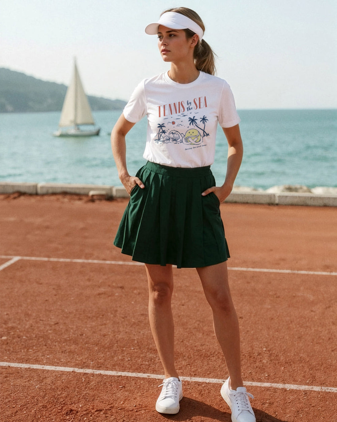 Woman in a tennis-themed outfit standing on a tennis court with a sailboat in the background.